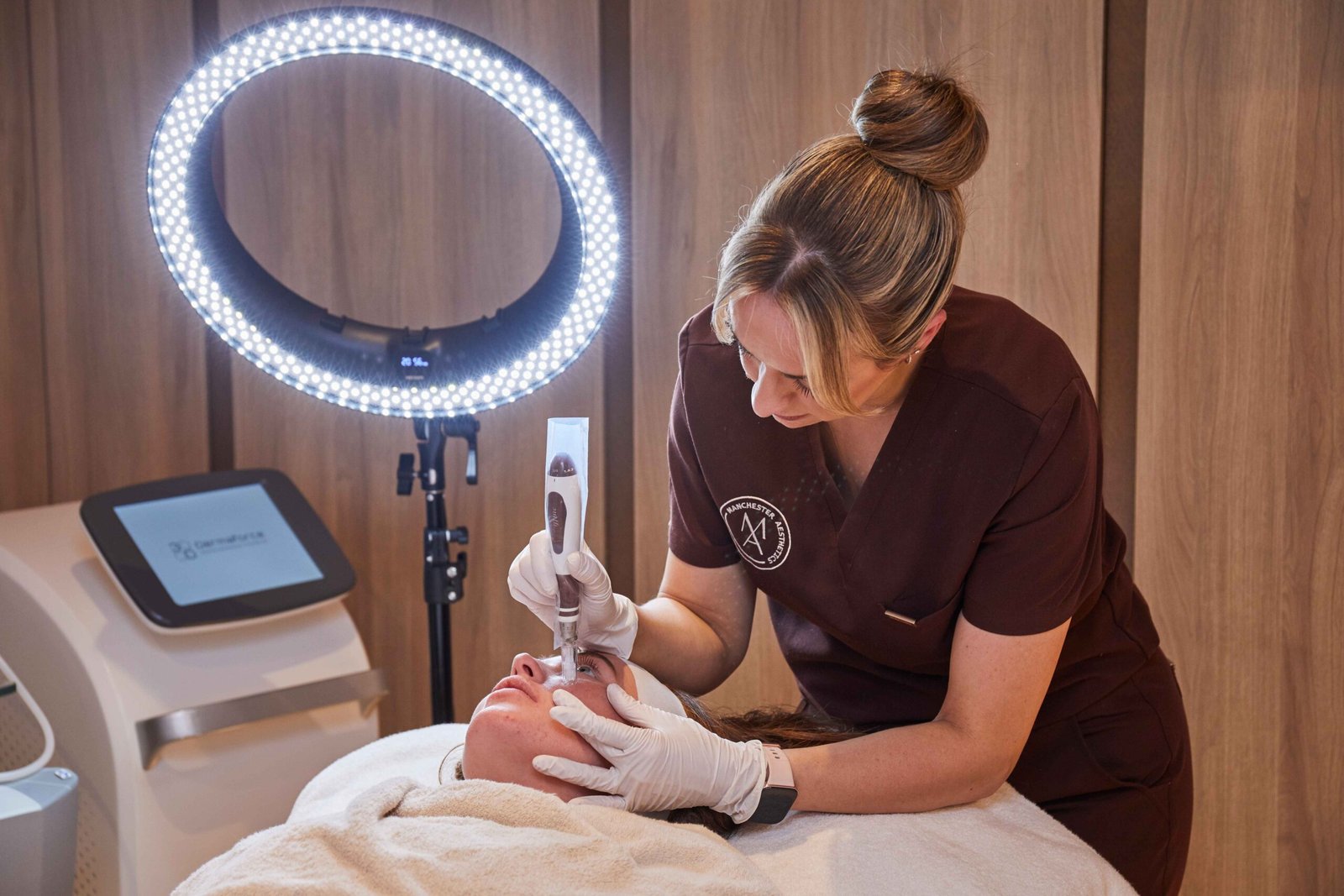 Microneedling facial treatment being performed by a trained practitioner at a Manchester clinic
